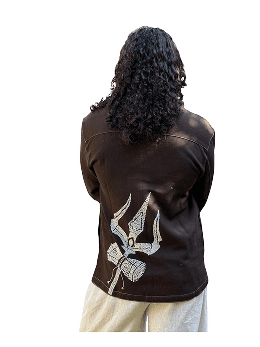 A hand-embroidered Kala cotton denim shacket embodying balance and strength, where the sacred Trishul becomes a symbol of calm power in motion.